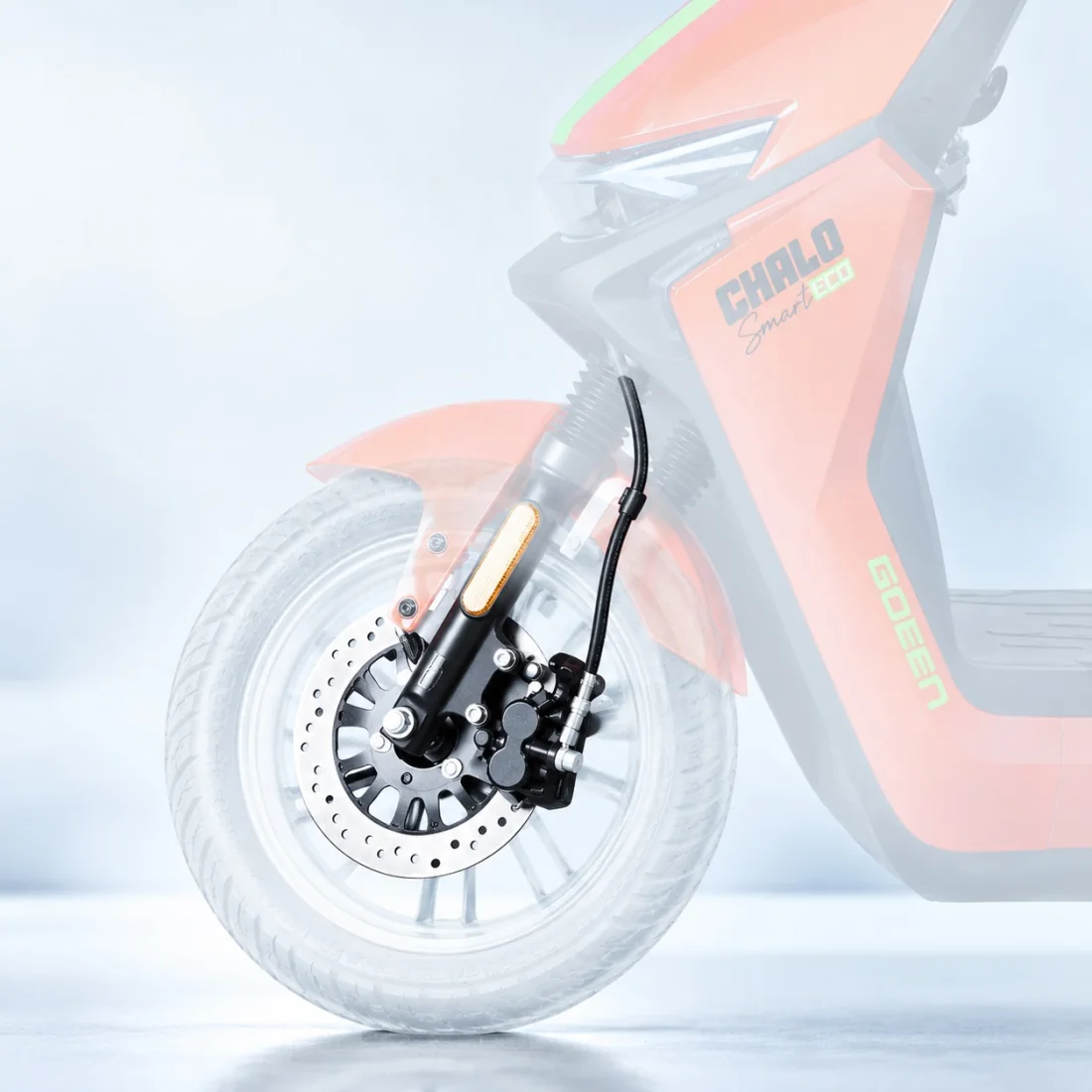 Front wheel of a CHALO SMART ECO, with the disc brake, caliper and fork picked out in colour against the faded body