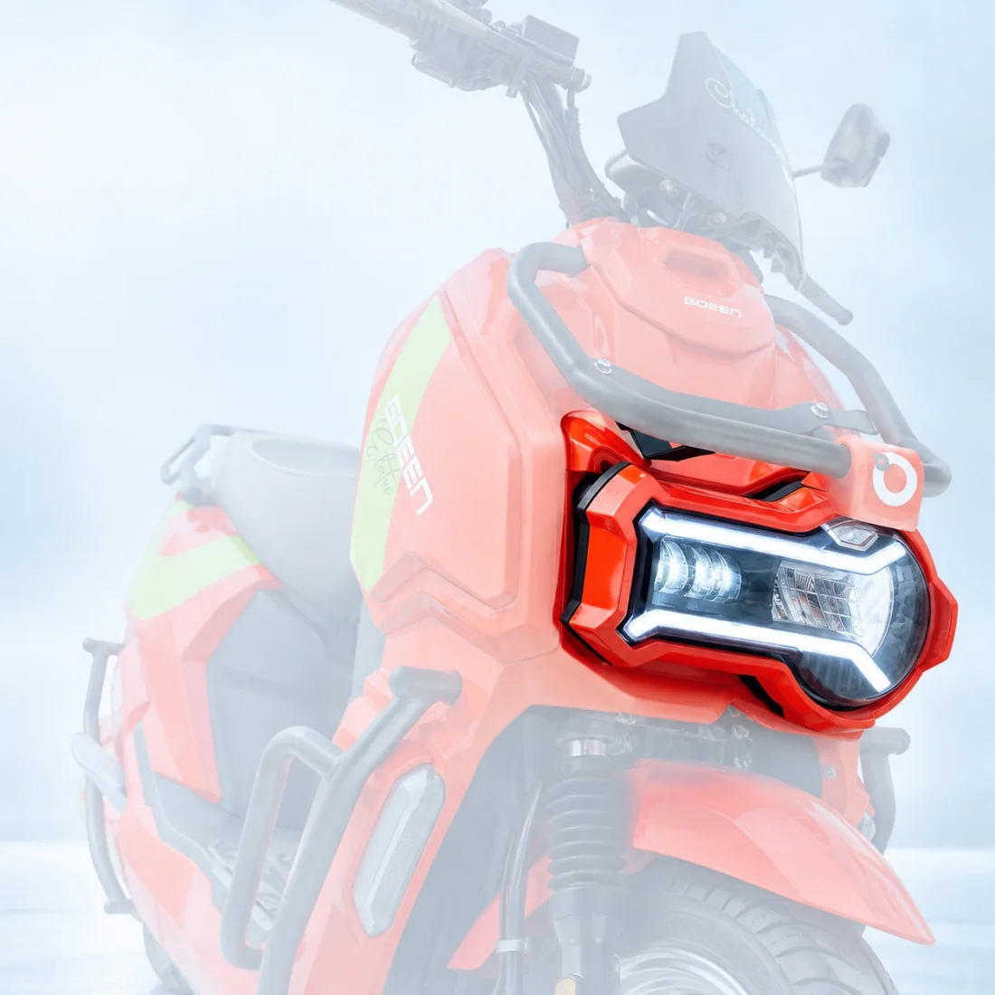 LED headlamp of a GOEEN scooter lit up, its daytime running signature tracing the housing